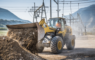 Wheel loader moving gravel at an electrical substation construction site.